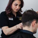 A skilled hairdresser expertly cutting a client's hair in a salon setting.