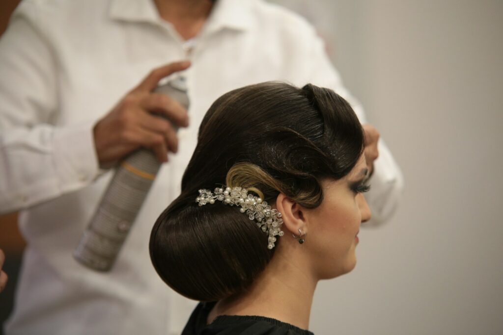 Cosmetologist consulting with client about hair style
