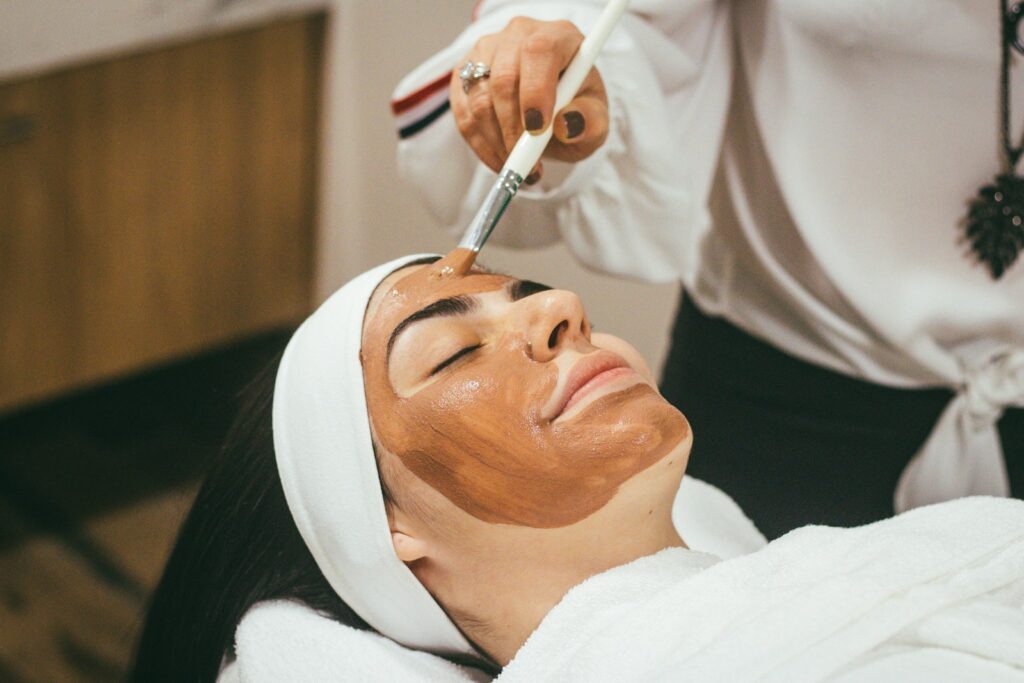Performing manicure or skincare treatment in salon